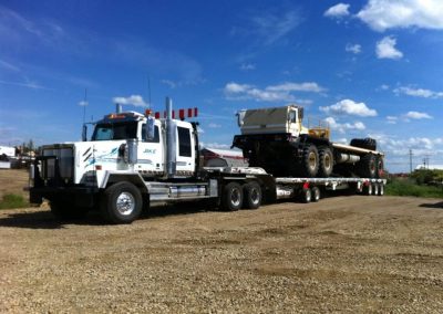 Transport Truck hauling heavy equipment