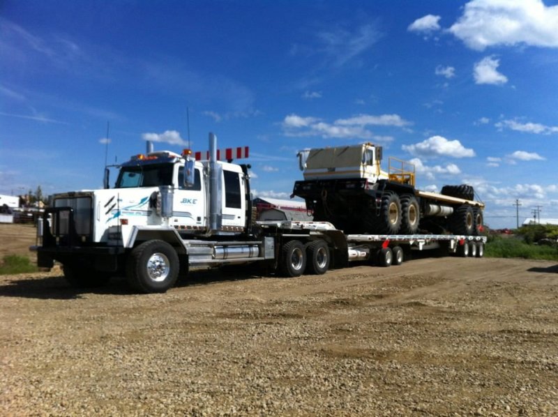 Transport Truck hauling heavy equipment